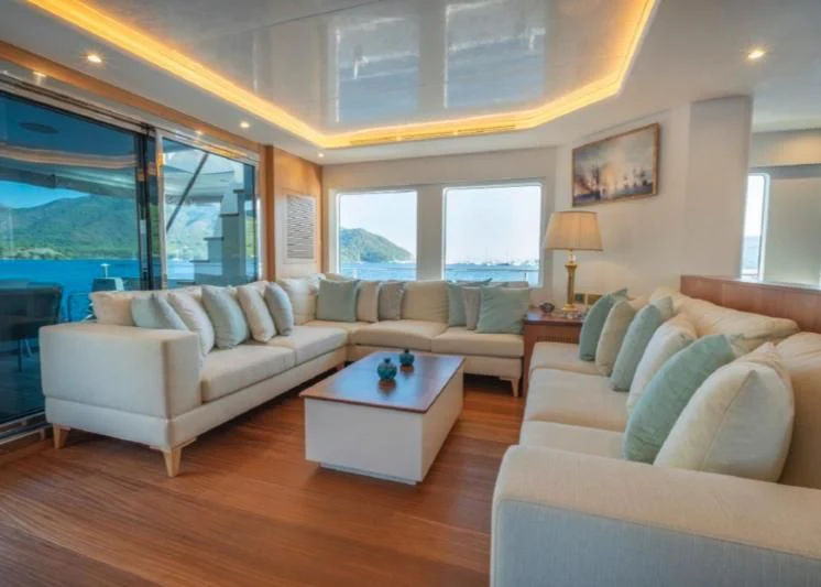 a living room with a large window aboard MURAL YACHTS 85 TRAWLER Yacht for Sale