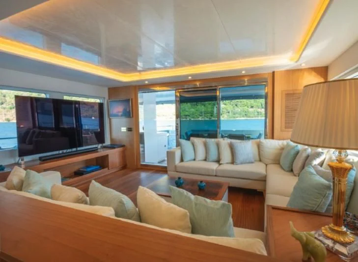 a living room with a large window aboard MURAL YACHTS 85 TRAWLER Yacht for Sale