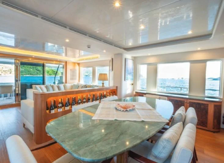 a dining table in a room aboard MURAL YACHTS 85 TRAWLER Yacht for Sale