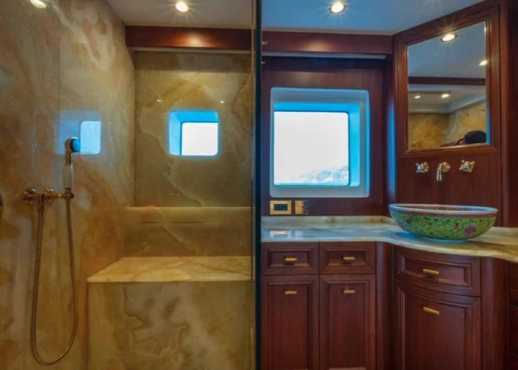a bathroom with a sink and a mirror aboard MURAL YACHTS 85 TRAWLER Yacht for Sale