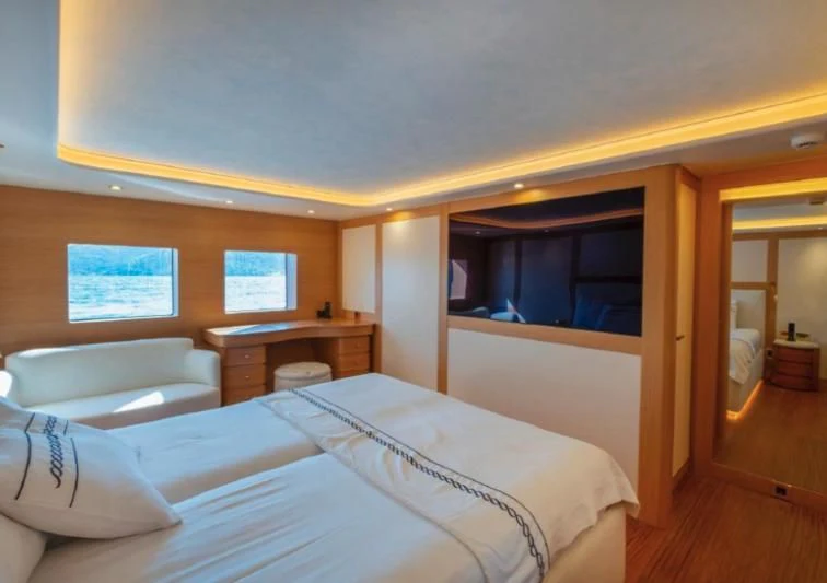 a room with a bed and a desk aboard MURAL YACHTS 85 TRAWLER Yacht for Sale