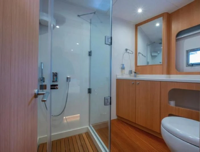 a bathroom with a shower and toilet aboard MURAL YACHTS 85 TRAWLER Yacht for Sale