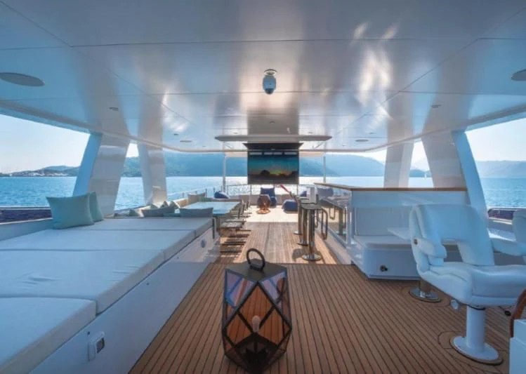 a room with a view of the ocean and the deck aboard MURAL YACHTS 85 TRAWLER Yacht for Sale