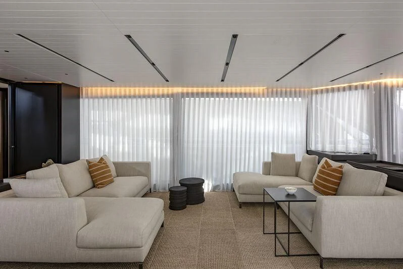 a living room with white couches aboard AMWAJ Yacht for Sale
