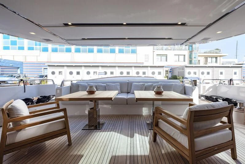 a room with tables and chairs aboard AMWAJ Yacht for Sale
