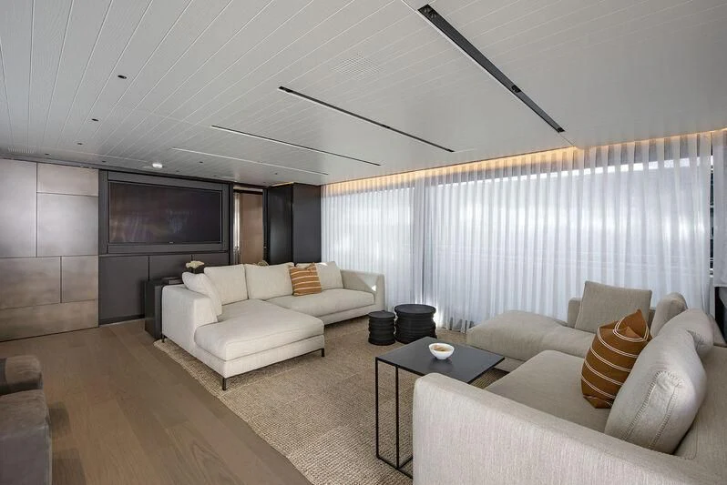a living room with a large screen aboard AMWAJ Yacht for Sale