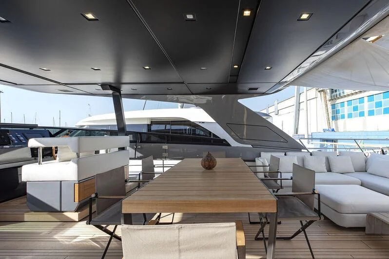 an airport with a table and chairs aboard AMWAJ Yacht for Sale