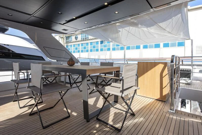 a room with chairs and tables aboard AMWAJ Yacht for Sale