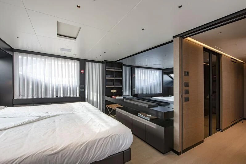 a room with a bed and a television aboard AMWAJ Yacht for Sale