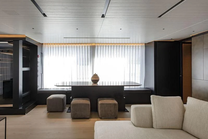 a room with couches and a table aboard AMWAJ Yacht for Sale