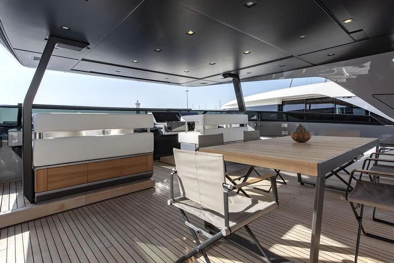 a room with a table and chairs aboard AMWAJ Yacht for Sale
