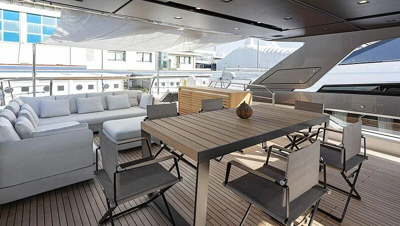 a room with a couch and a table and chairs aboard AMWAJ Yacht for Sale