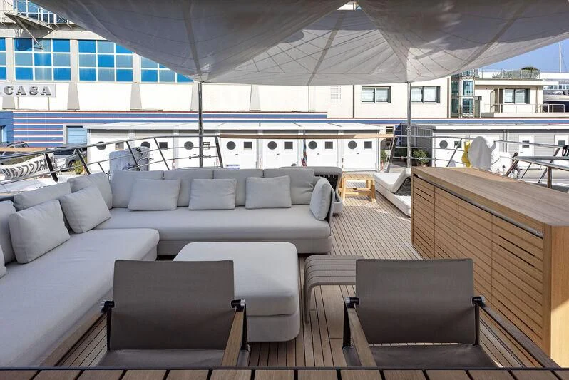 a living room with a couch and a table aboard AMWAJ Yacht for Sale
