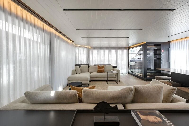 a living room with a large window aboard AMWAJ Yacht for Sale