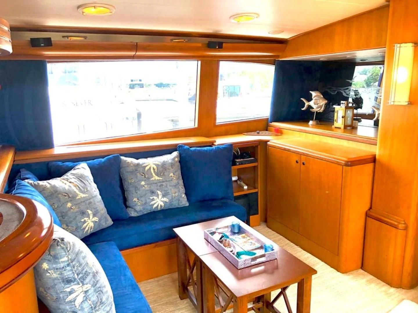 a living room with a blue couch aboard PRIME TIME Yacht for Sale