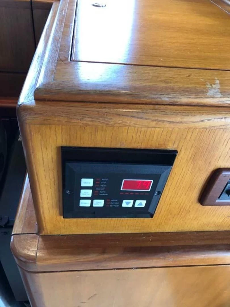 a black rectangular electronic device on a wooden surface aboard PRIME TIME Yacht for Sale