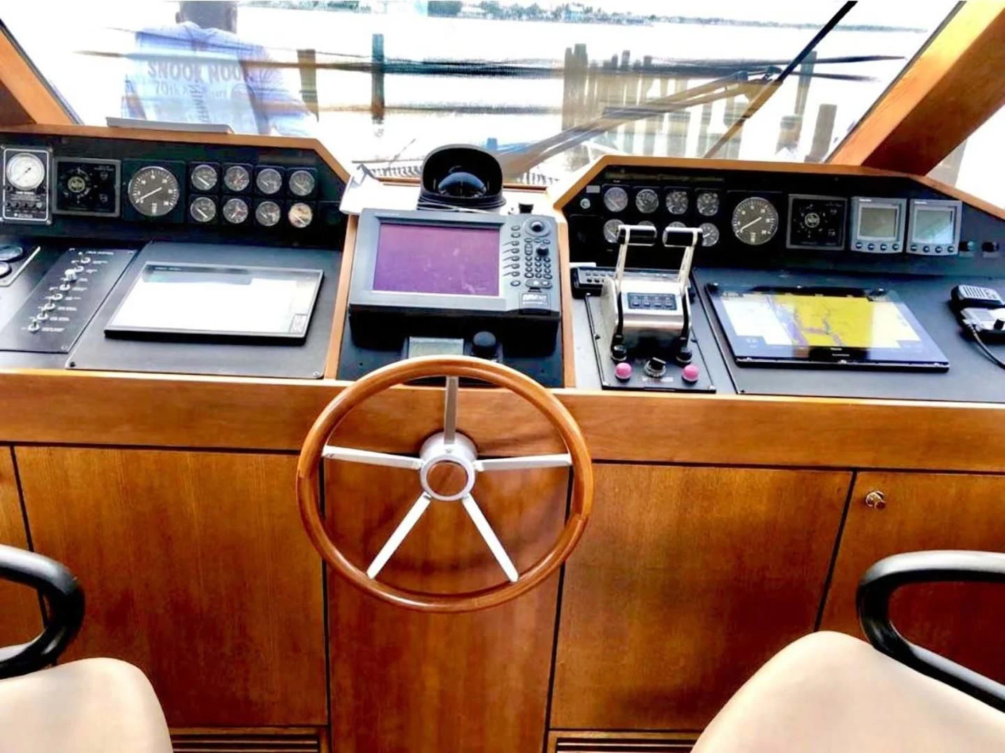 a wooden desk with a chair and a radio aboard PRIME TIME Yacht for Sale
