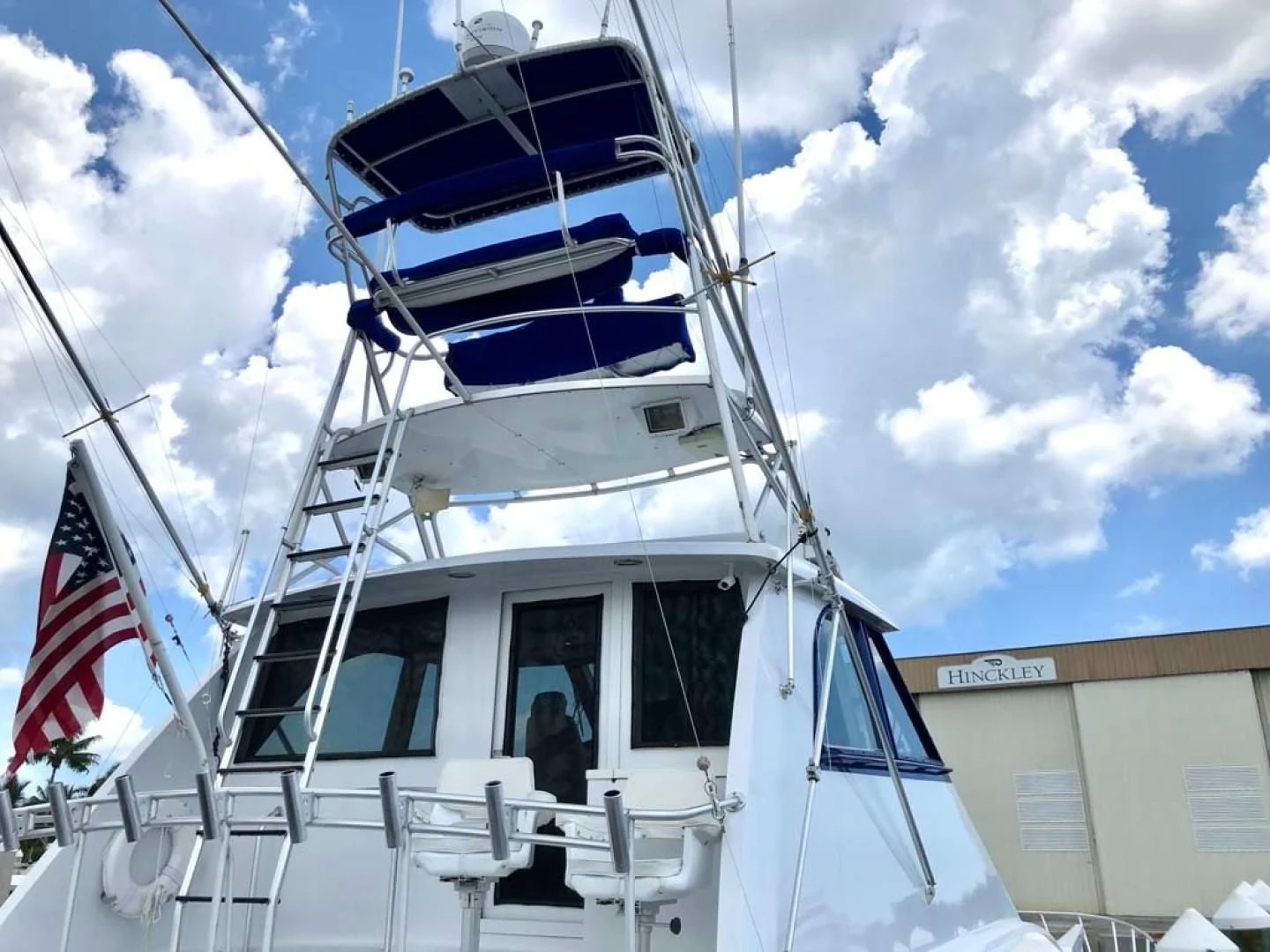 a boat with a flag on the front aboard PRIME TIME Yacht for Sale