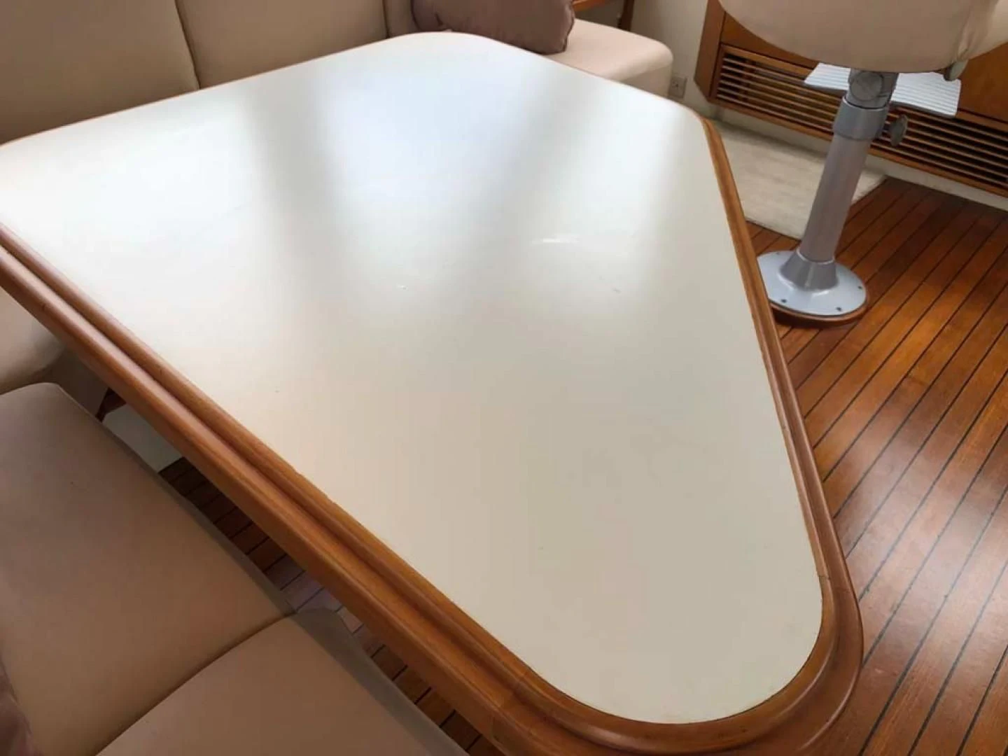 a round white rectangular object on a wooden surface aboard PRIME TIME Yacht for Sale