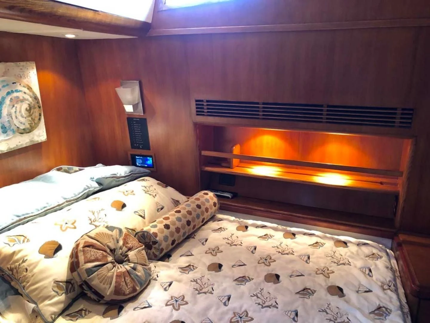 a bed with a fireplace aboard PRIME TIME Yacht for Sale