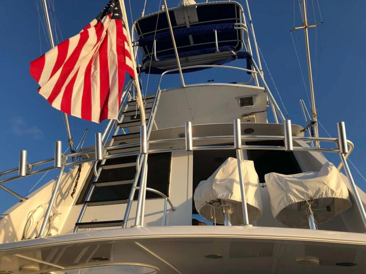 a boat with a flag on the front aboard PRIME TIME Yacht for Sale