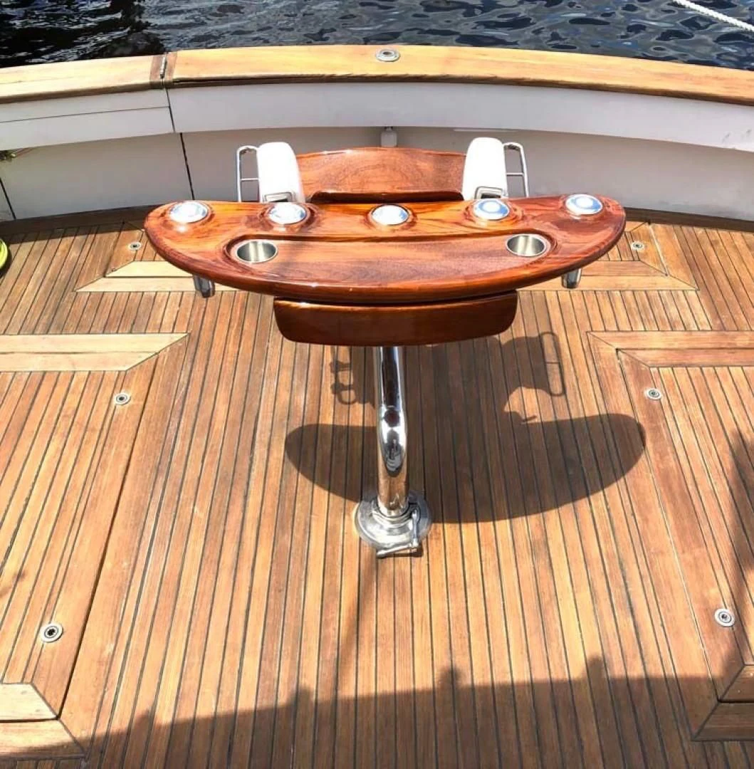 a table on a wooden floor aboard PRIME TIME Yacht for Sale