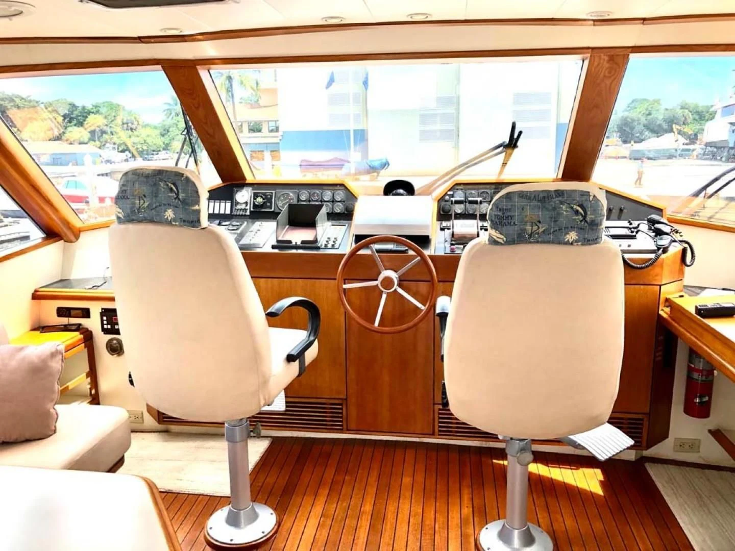 a room with a couple of chairs and a table with a large window aboard PRIME TIME Yacht for Sale