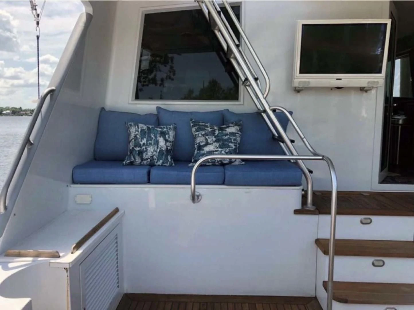 a blue couch on a boat aboard PRIME TIME Yacht for Sale