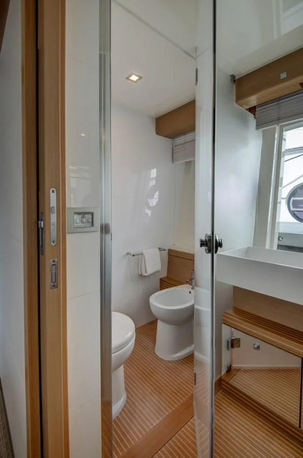 a bathroom with a toilet and a sink aboard GOLDEN BELLE Yacht for Sale