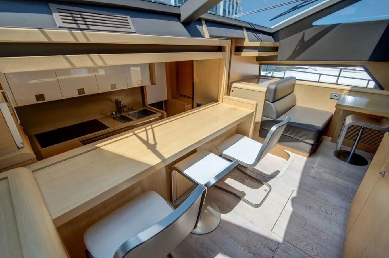 a room with a table chairs and a sink aboard GOLDEN BELLE Yacht for Sale
