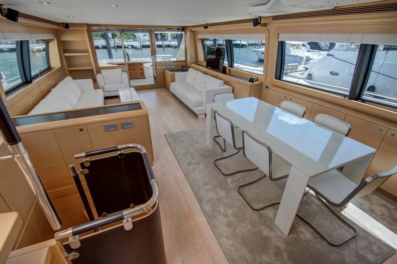 a room with a table chairs and a couch aboard GOLDEN BELLE Yacht for Sale