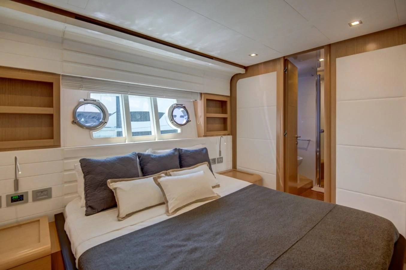 a bed with a blue comforter aboard GOLDEN BELLE Yacht for Sale