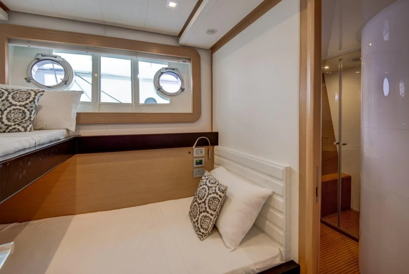 a room with a bed and a window aboard GOLDEN BELLE Yacht for Sale