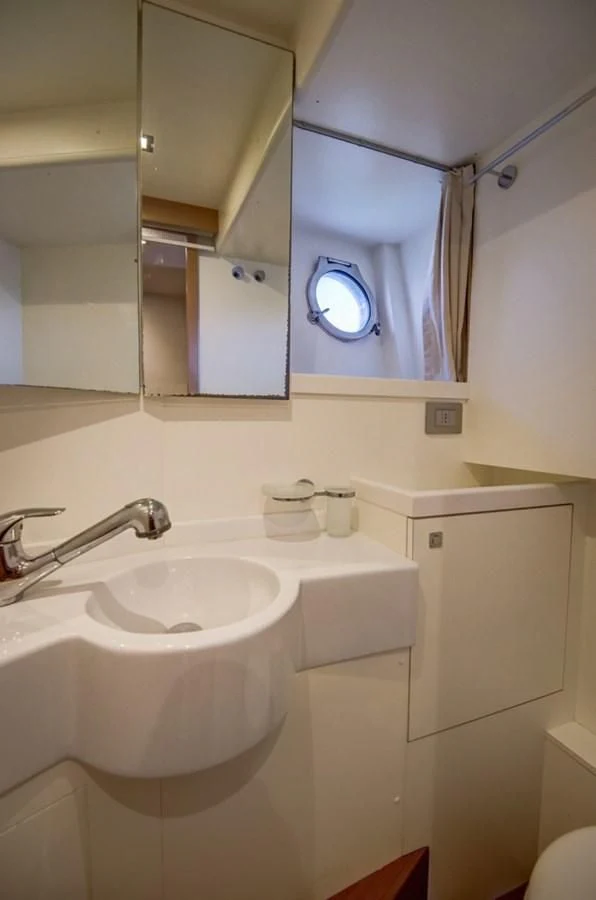 a bathroom with a mirror and a sink aboard GOLDEN BELLE Yacht for Sale