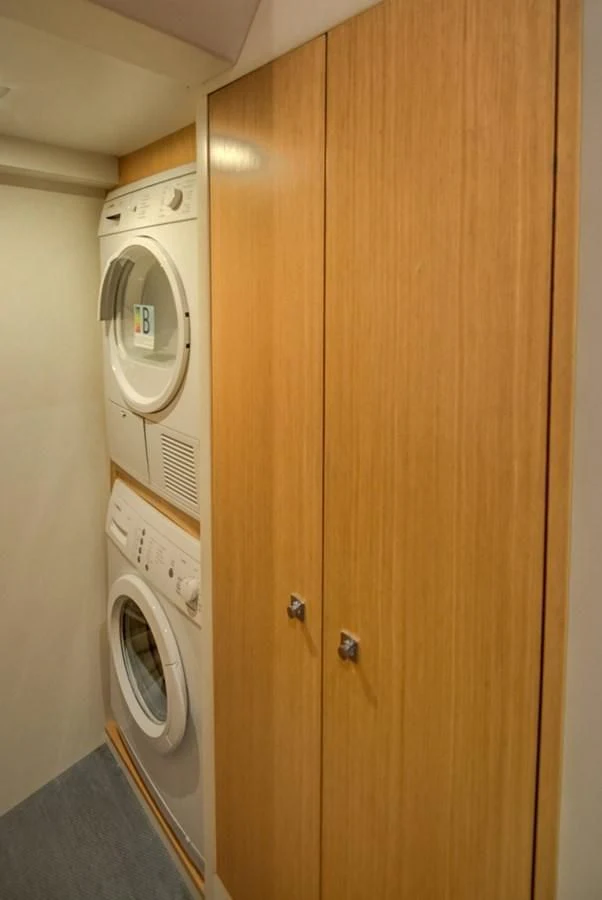 a closet with a washing machine aboard GOLDEN BELLE Yacht for Sale