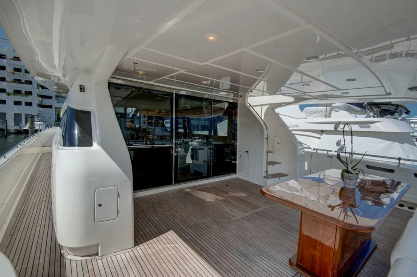 a room with a table and a large window aboard GOLDEN BELLE Yacht for Sale