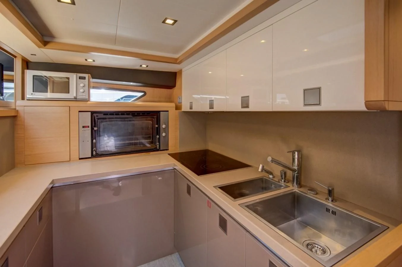 a kitchen with white cabinets aboard GOLDEN BELLE Yacht for Sale