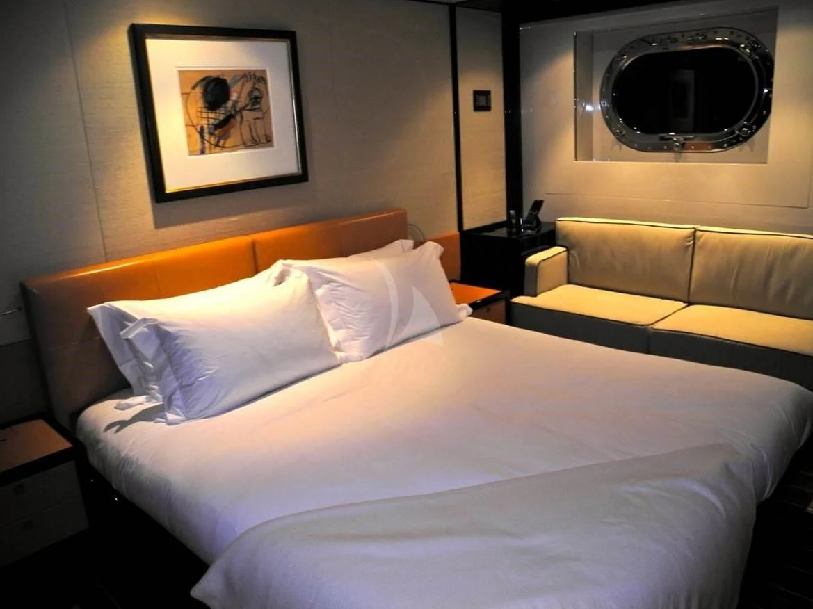 a bed with white sheets aboard SERENDIPITY I Yacht for Charter