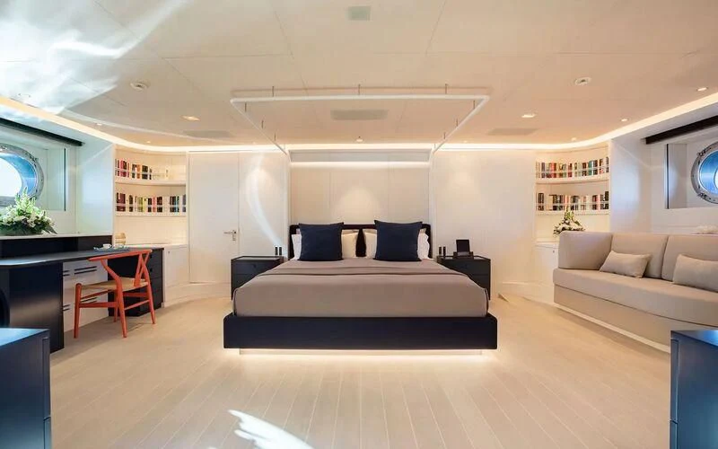 a large white room with a bed and a couch aboard SERENDIPITY I Yacht for Charter