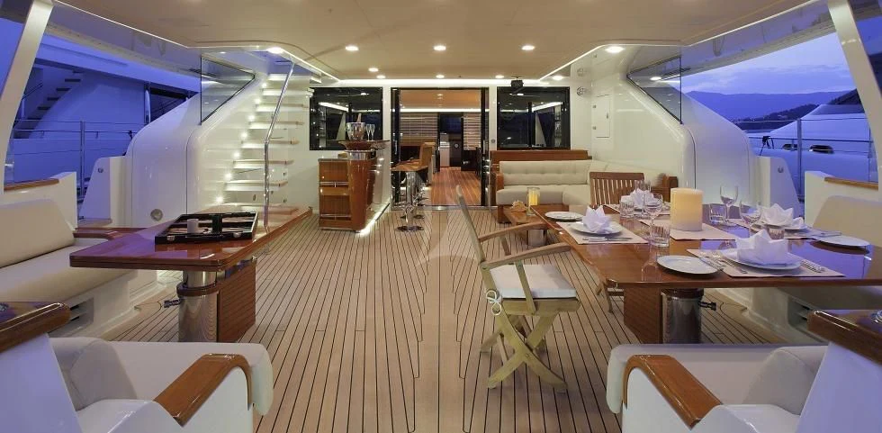 a room with tables and chairs aboard SERENDIPITY I Yacht for Charter