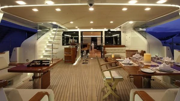 a room with tables and chairs aboard SERENDIPITY I Yacht for Charter