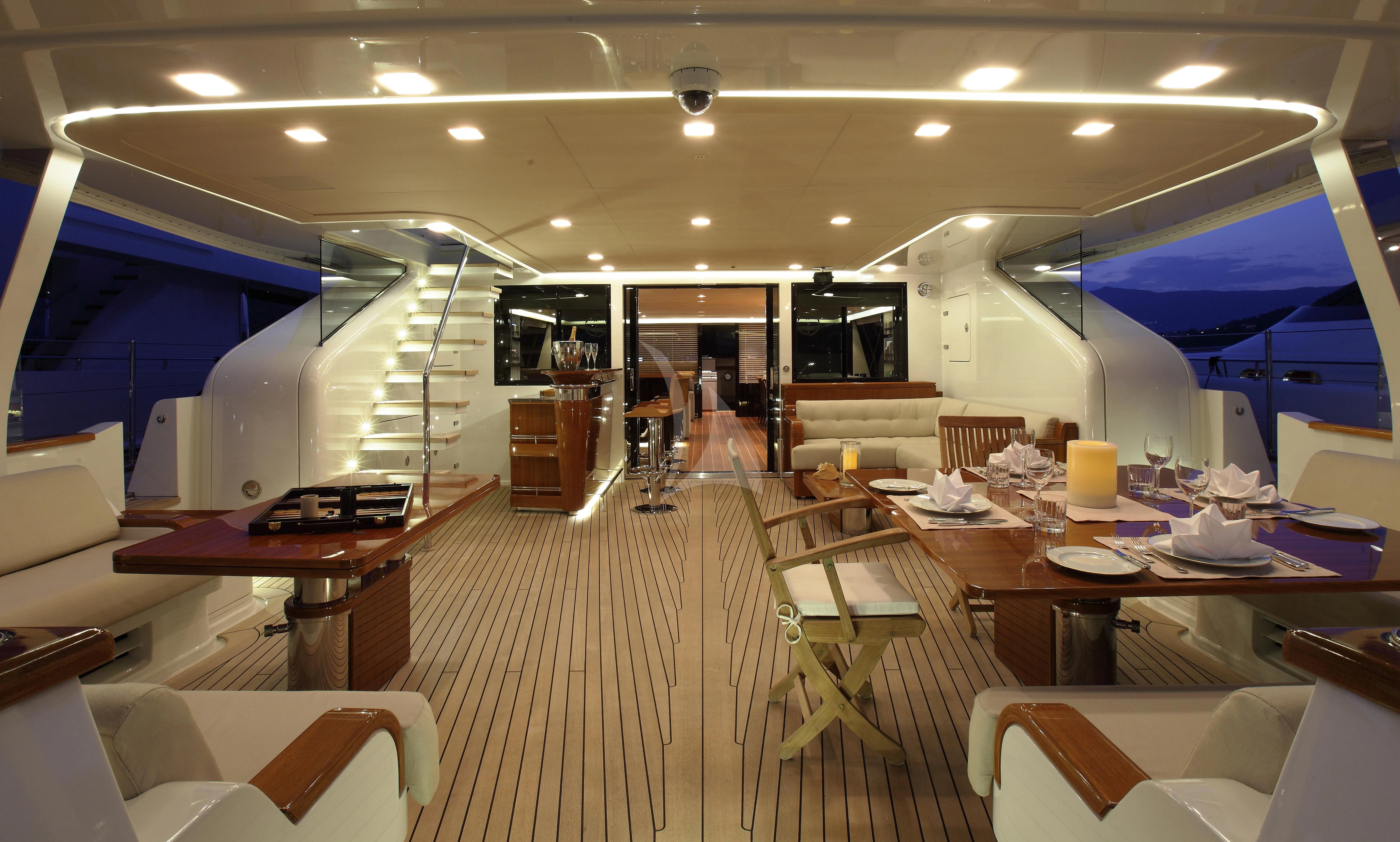 a room with tables and chairs aboard SERENDIPITY I Yacht for Charter