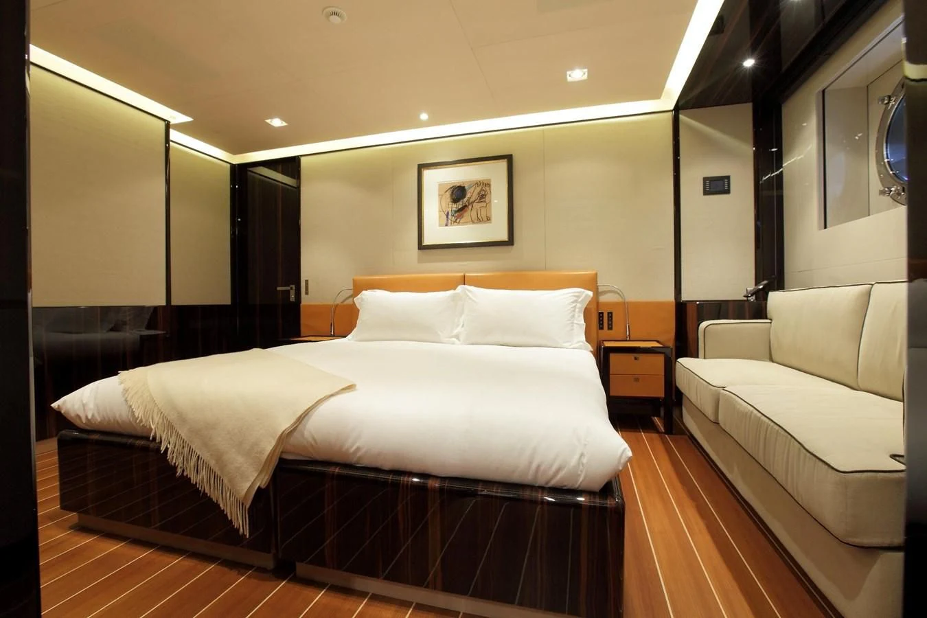 a room with a bed and a couch aboard SERENDIPITY I Yacht for Charter
