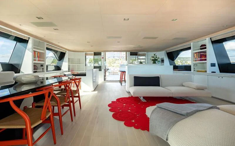 a living room with a red rug aboard SERENDIPITY I Yacht for Charter