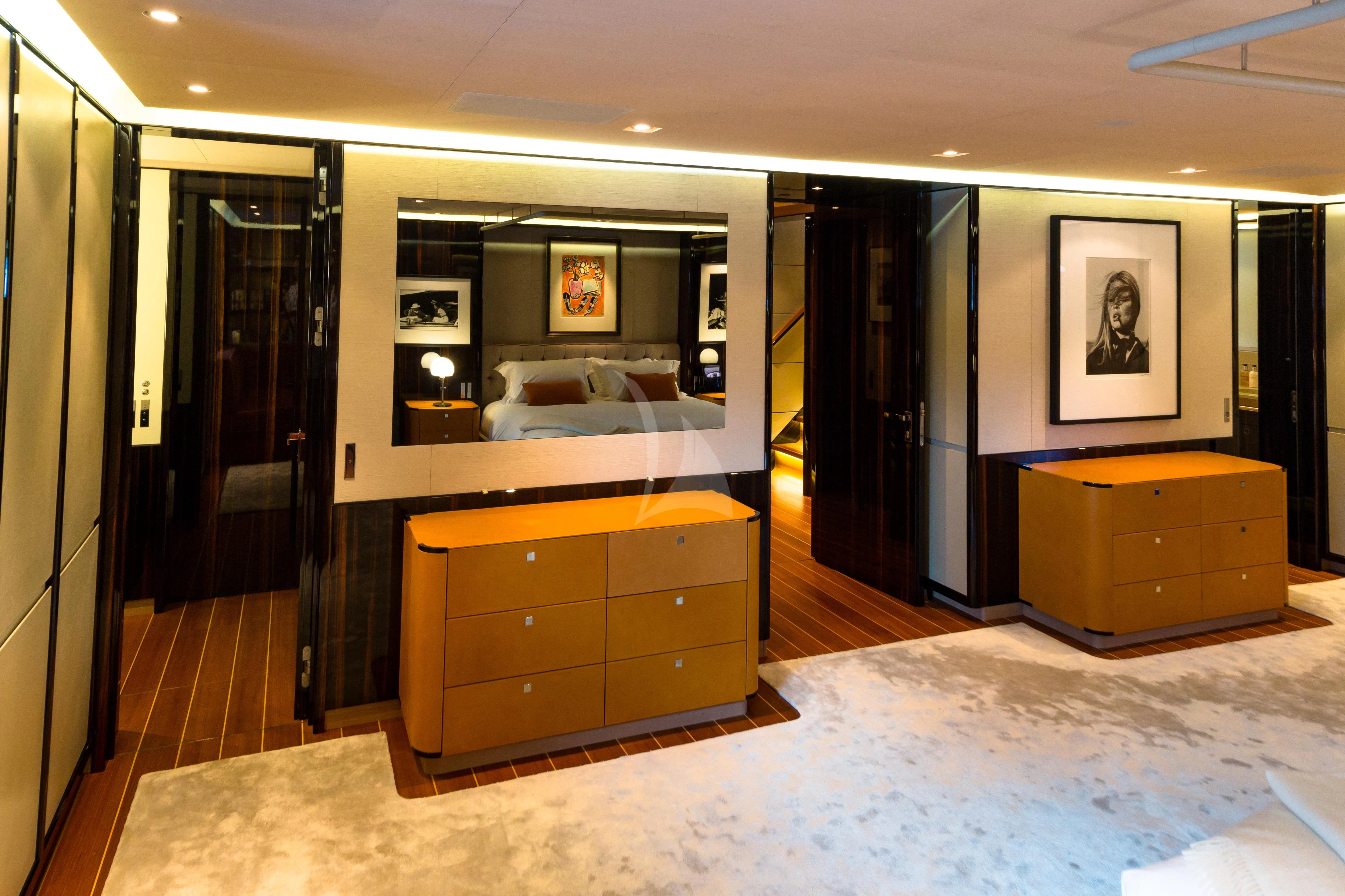 a room with a bed and a dresser aboard SERENDIPITY I Yacht for Charter