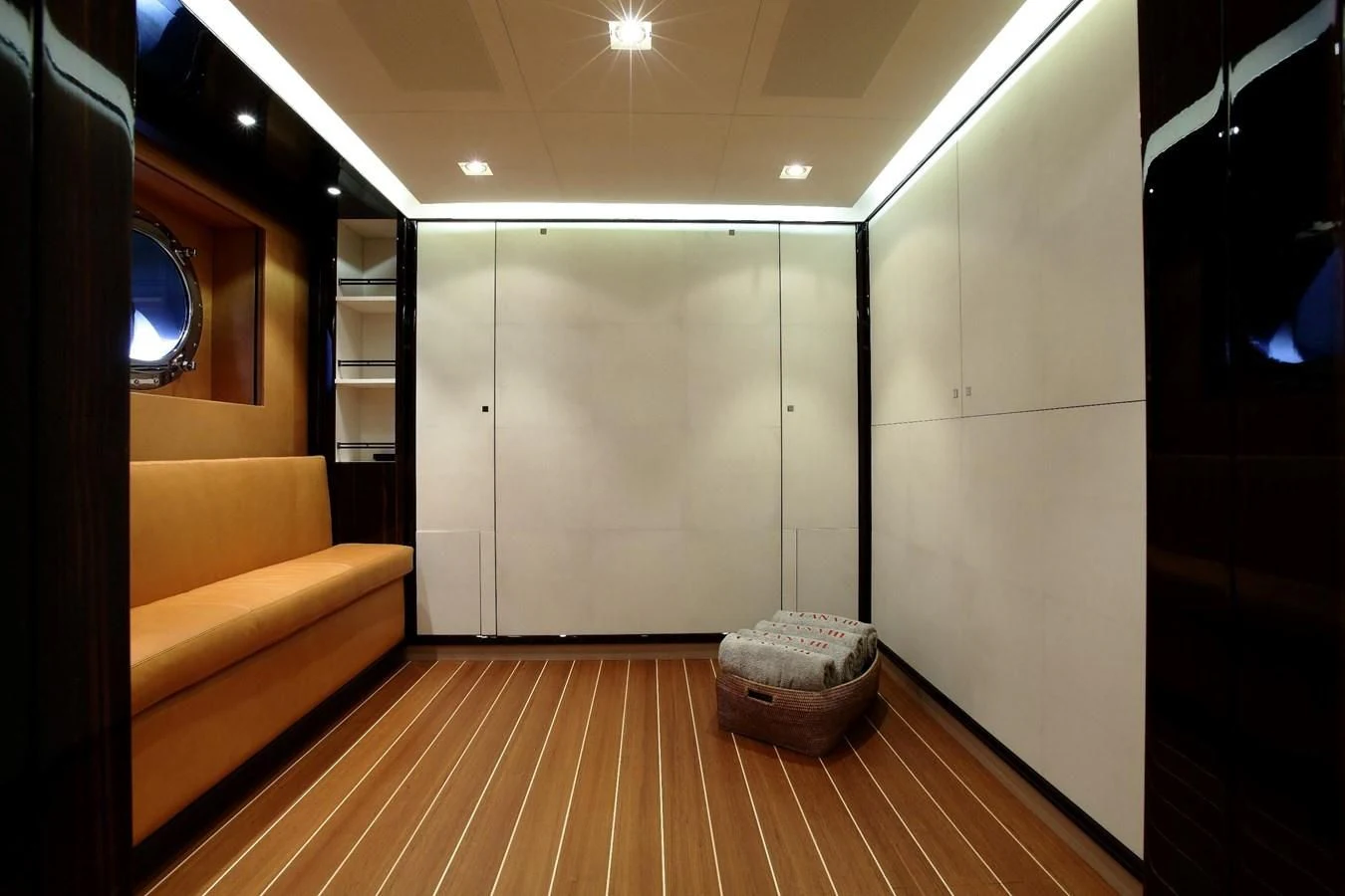 a room with a wood floor and a couch and a mirror aboard SERENDIPITY I Yacht for Charter