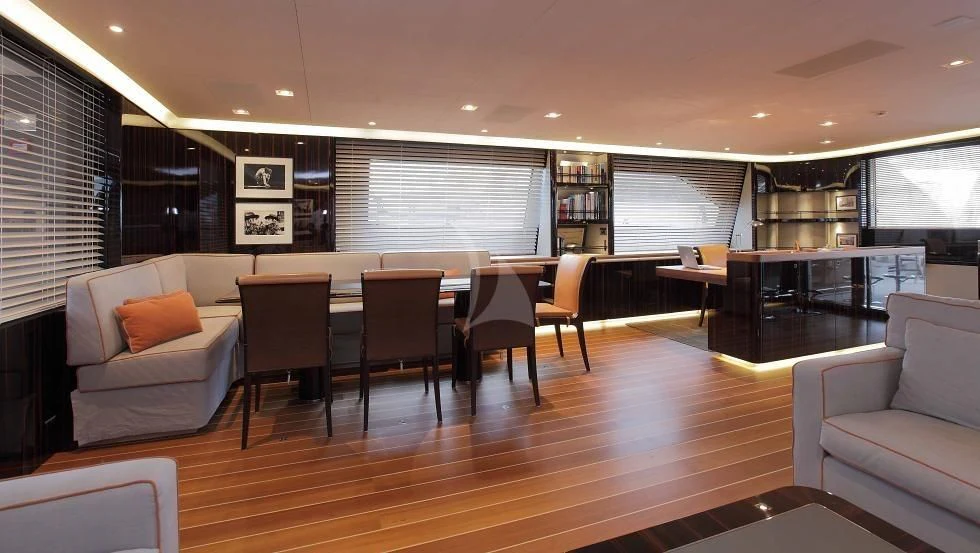 a large room with a table and chairs aboard SERENDIPITY I Yacht for Charter