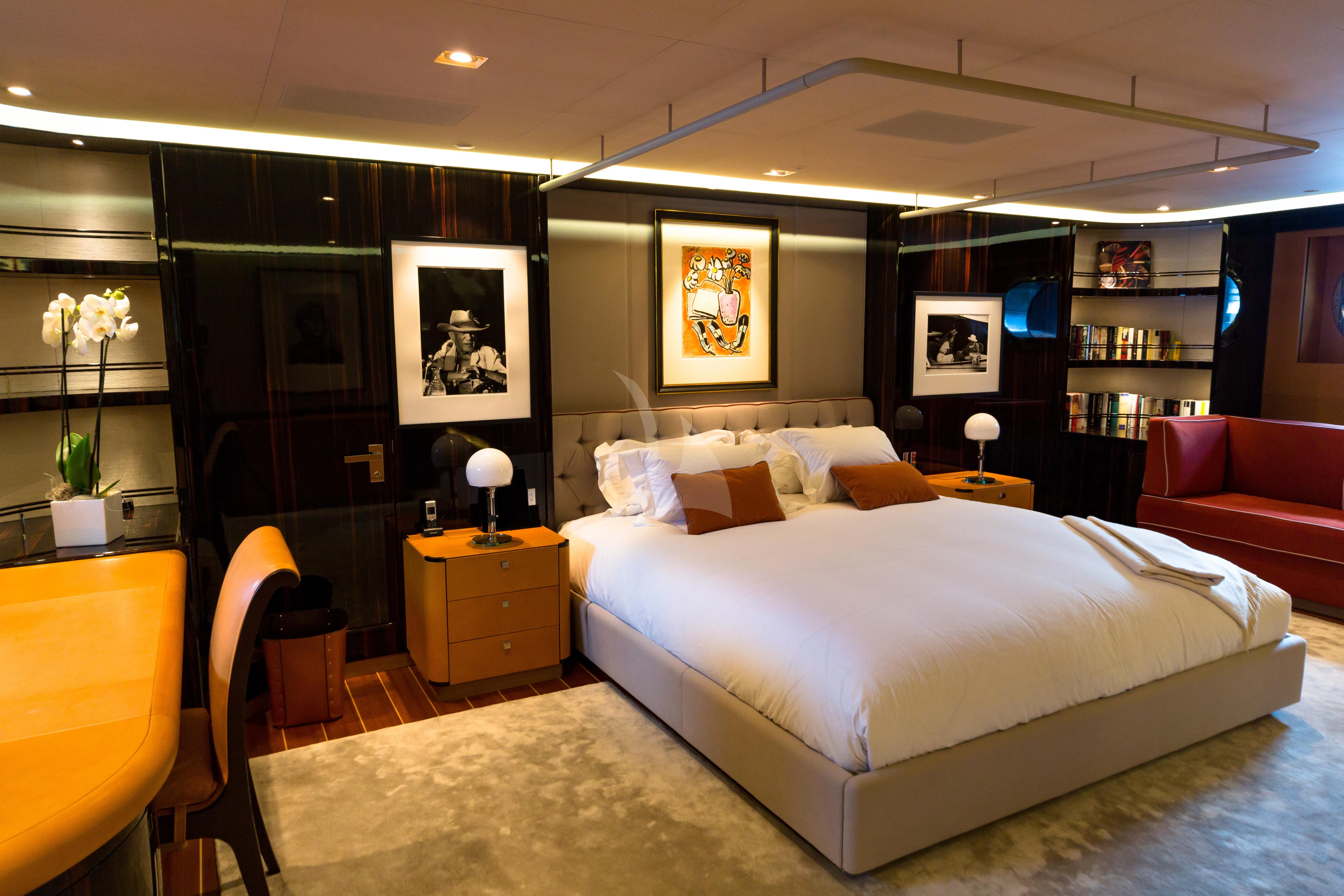 a bedroom with a bed and a desk aboard SERENDIPITY I Yacht for Charter