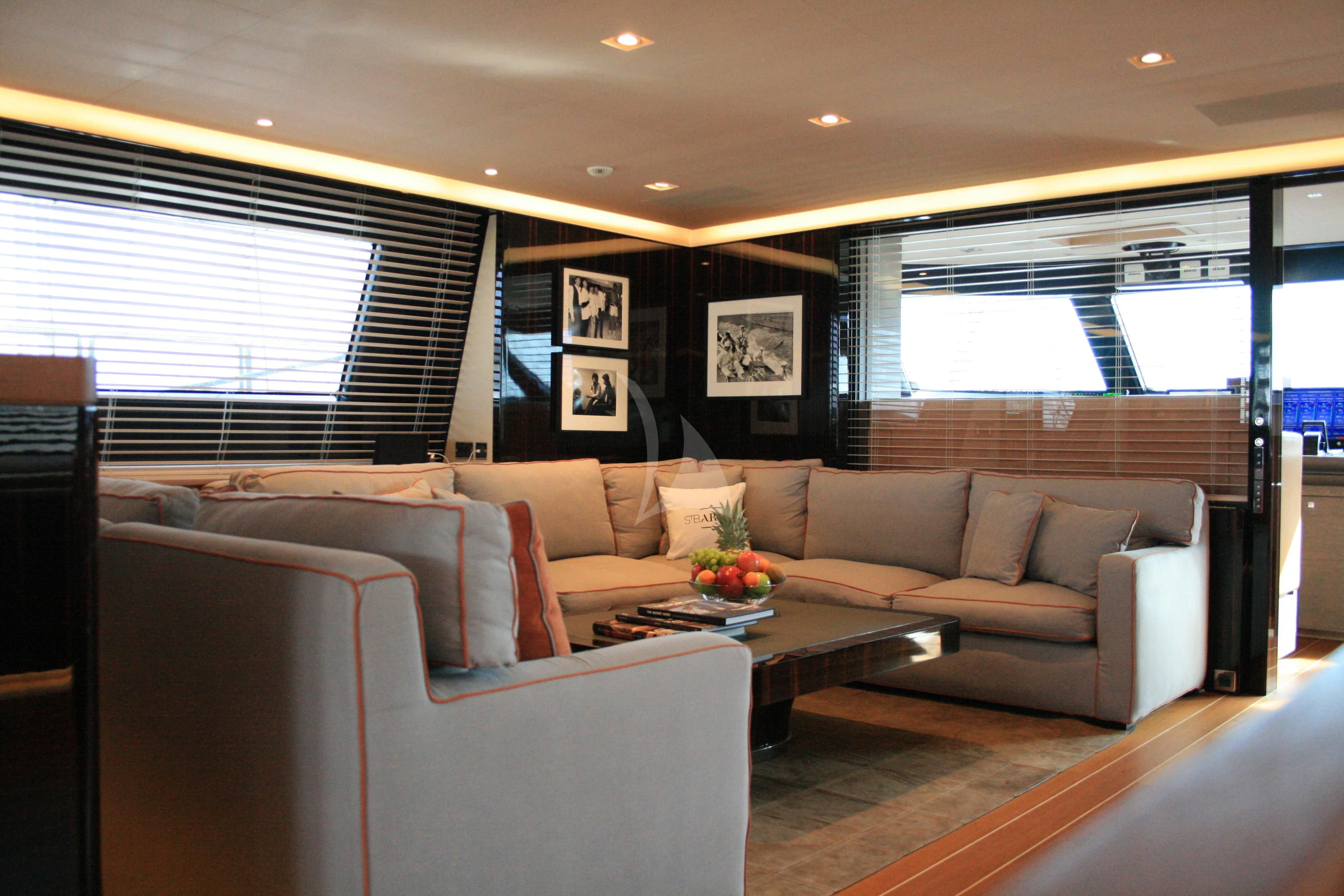a living room with a couch and a coffee table aboard SERENDIPITY I Yacht for Charter