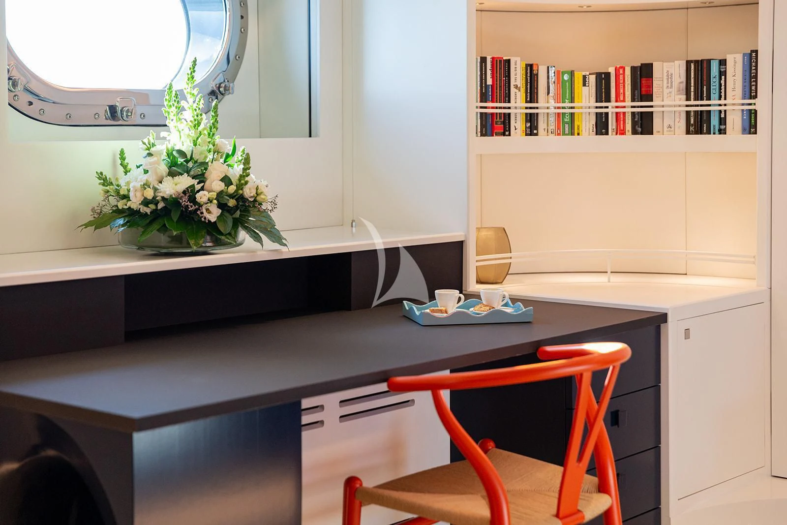 a desk with a chair and a window aboard SERENDIPITY I Yacht for Charter